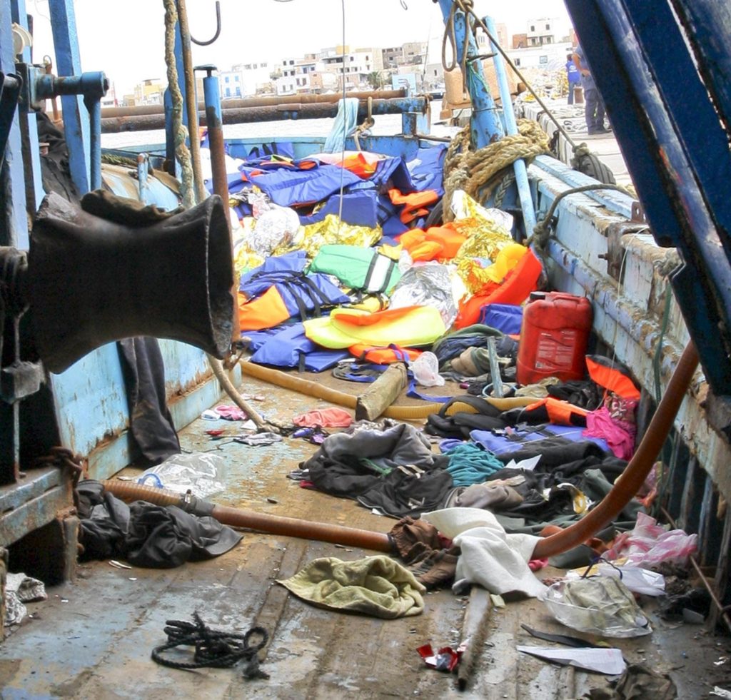 Uno dei due barconi, a bordo del quale viaggiavano centinaia di migranti, approdato al Porto di Lampedusa, 3 ottobre 2013. L'altro barcone è, invece, affondato durante la navigazione e il bilancio, alla fine, è di 368 morti, 20 dispersi, 155 persone salvate. Ansa/Claudio Peri
