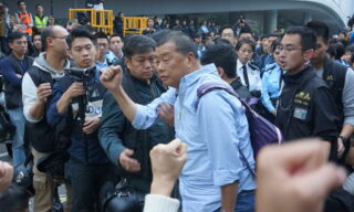 Hong Kong's pro-democracy media tycoon Jimmy Lai arrested and charged epa08254476 (FILE) - Hong Kong Police arrest media tycoon Jimmy Lai (C) at the main pro-democracy Umbrella Movement site in Admiralty, Hong Kong, China, 11 December 2014 (re-issued 28 February 2020). According to media reports, Apple Daily founder Jimmy Lai was arrested on 28 February and charged with illegal assembly and intimidation, respectively for taking part in an anti-government march in August 2019 and for a clash with a journalist in 2017. Lai is scheduled to appear in court on 5 May 2020 along with two other pro-democracy figures who were arrested the same day. EPA/STR