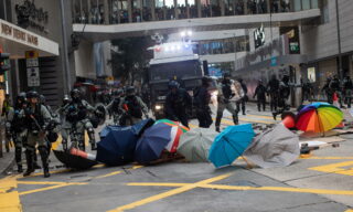 Pro-democracy rally in Hong Kong epa08140604 Riot police clear a makeshift barricade during a pro-democracy rally in Hong Kong, China, 19 January 2020. Hong Kong has entered its eighth month of mass protests, originally triggered by a now withdrawn extradition bill, that have since turned into a wider pro-democracy movement. EPA/JEROME FAVRE