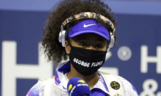 2020 US Open Tennis Championships in New York epa08655488 Naomi Osaka of Japan wears a George Floyd face mask as she enters the court to play Shelby Rogers of the USA before their match on the ninth day of the US Open Tennis Championships at the USTA National Tennis Center in Flushing Meadows, New York, USA, 08 September 2020. Due to the coronavirus pandemic, the US Open is being played without fans and runs from 31 August through 13 September. EPA/JASON SZENES