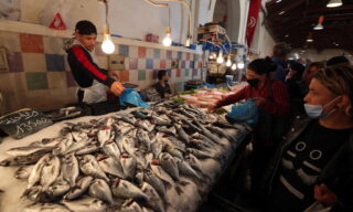 Muslims shop on the first day of the holy month of Ramadan epa09132581 A Tunisian man sells fish on the first day of the Muslim holy month of Ramadan at a market in Tunis, Tunisia, 13 April 2021. Muslims began observing the dawn-to-dusk fast for the holy month of Ramadan across many parts of the Middle East on Tuesday 13 April. to draw worshippers closer to God through sacrifice, remembrance and heightened spirituality. EPA/MOHAMED MESSARA