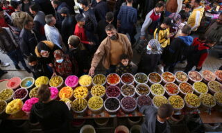 Palestinians prepare for Ramadan epa09132804 A shop vendor sells pickles in the old city of West bank town of Hebron, 13 April 2021. Muslims around the world celebrate the holy month of Ramadan by praying during the night time and abstaining from eating, drinking, and sexual acts during the period between sunrise and sunset. Ramadan is the ninth month in the Islamic calendar and it is believed that the revelation of the first verse in Koran was during its last 10 nights. EPA/ABED AL HASHLAMOUN