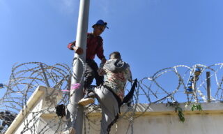Migrants cross from Morocco into Ceuta, Spain epa09210804 Migrants climb the fence in the northern town of Fnideq in an attempt to cross the border from Morocco to the Spanish enclave of Ceuta, in North Africa 18 May 2021. In little over 24 hours a total of almost 8,000 people entered into the Spanish city of Ceuta, located in the North African coast, by sea side and hundreds of migrants continue to attempt doing so. The Spanish authorities have deployed the army to patrol on the border separating Ceuta in the Spanish side from the Moroccan side, in a bid to control this latest surge of entry attempts. EPA/JALAL MORCHIDI