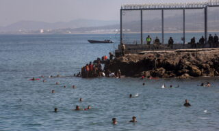 Spanish city of Ceuta in crisis with influx migrants epa09209366 Migrants arrive swimming to cross the border of Tarajal in Ceuta, Spain, 18 May 2021. On the night of 18 May, a total of 5,000 Moroccan nationals entered into the Spanish city of Ceuta, loacted in the North African coast, by sea side and hundreds of migrants continue to attempt doing so. The Spanish authorities have deployed the army to patrol on the border separating Ceuta in the Spanish side from the Moroccan side, in a bid to control this latest surge of entry attempts. EPA/BRAIS LORENZO