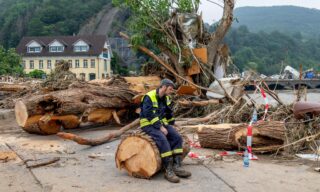 >>>ANSA/ NORD EUROPA IN GINOCCHIO PER IL MALTEMPO,141 MORTI IN GERMANIA A helper sits during clearing work on the cut trunk of an uprooted tree in the district Kreuzberg of Altenahr, western Germany, on July 17, 2021 after heavy rain hit parts of the country, causing widespread flooding and major damage. - Rescue workers scrambled on July 17 to find survivors and victims of the devastation wreaked by the worst floods to hit western Europe in living memory, which have already left more than 150 people dead and dozens more missing. (Photo by Torsten SILZ / AFP)