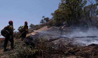 River Fire in Northern California Sierras epa09345043 Hot Shots Big Bear crew perform mop up duties on a hillside situated along Road 600 in Raymond, CA as firefighters battle The River Fire in the high Sierra foothills of Madera and Mariposa counties outside of Oakhurst, California, USA, 14 July 2021. EPA/DAVID ODISHO